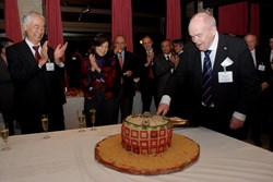 Ninth ITER Council: A cake in the form of the ITER Tokamak is cut by retiring Chair Academician Evgeny Velikhov. (Click to view larger version...)